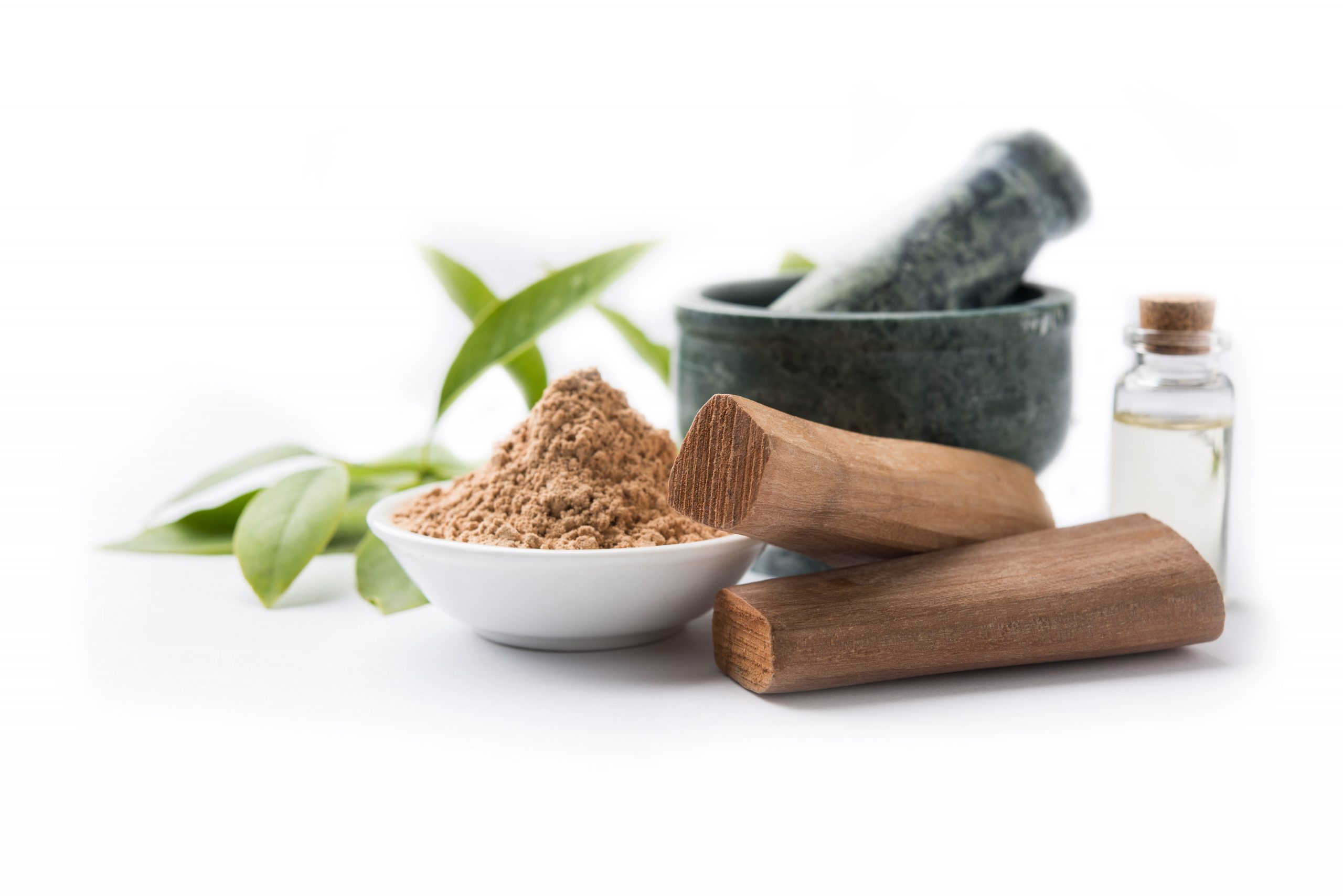 Chandan or sandalwood powder with traditional mortar, sandalwood sticks, perfume or oil and green leaves. selective focus Sandalwood - Agricultural products for every home